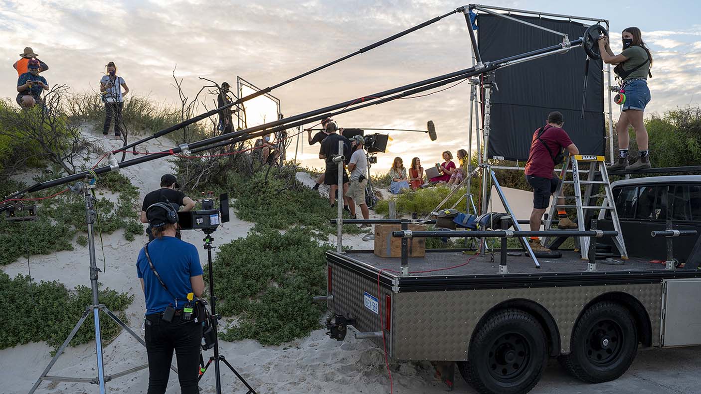 Behind the scenes of a film production with equipment on a truck