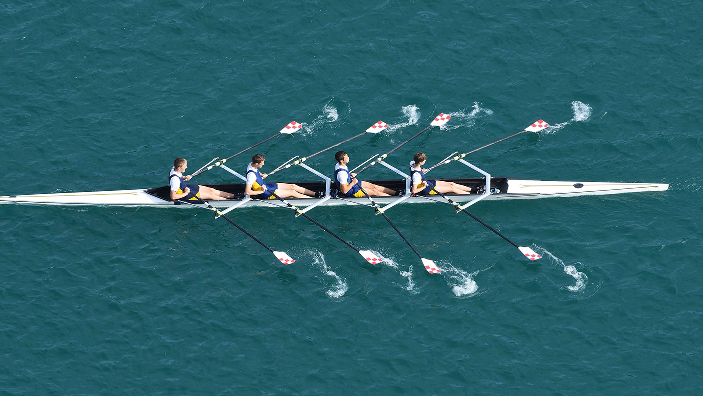 Upper view of quadruple scull rowing team during the race