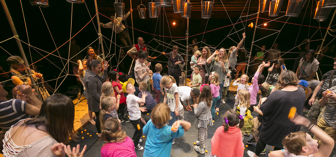 Kids and families playing during a performance.
