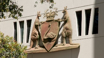 A closeup photo of the WA State Government coat of arms on Parliament House