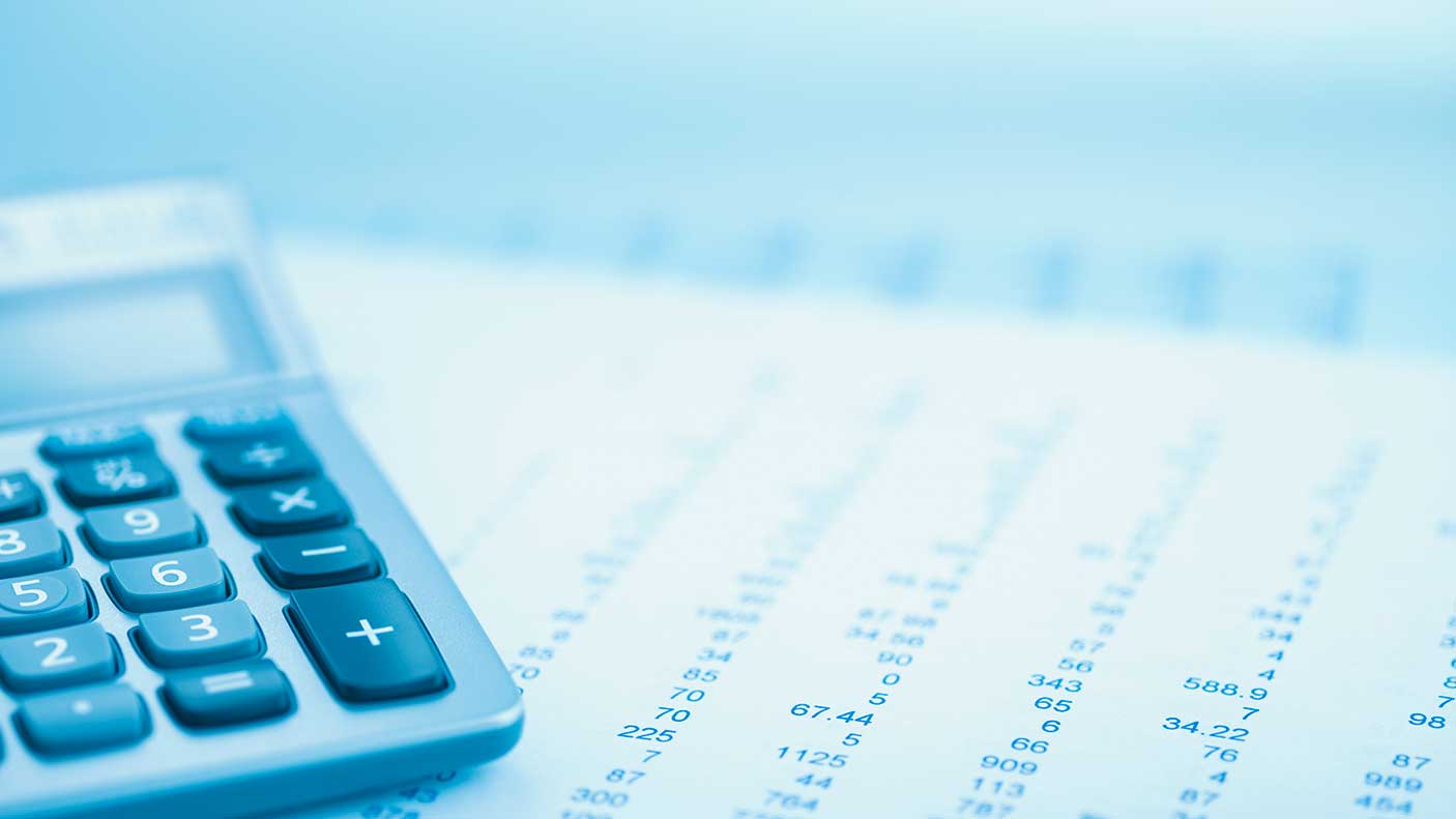 Close up of a calculator and financial information on a page