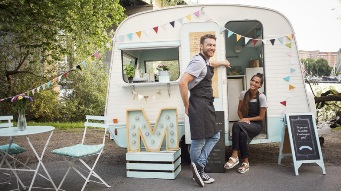 Stock image of a couple in front of their food van