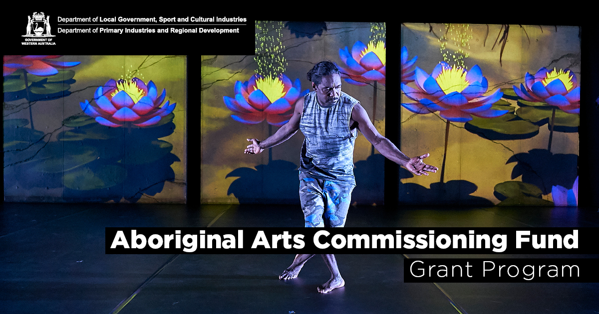 An Aboriginal artist performing on stage with a colourful background of illustrated water lillies.