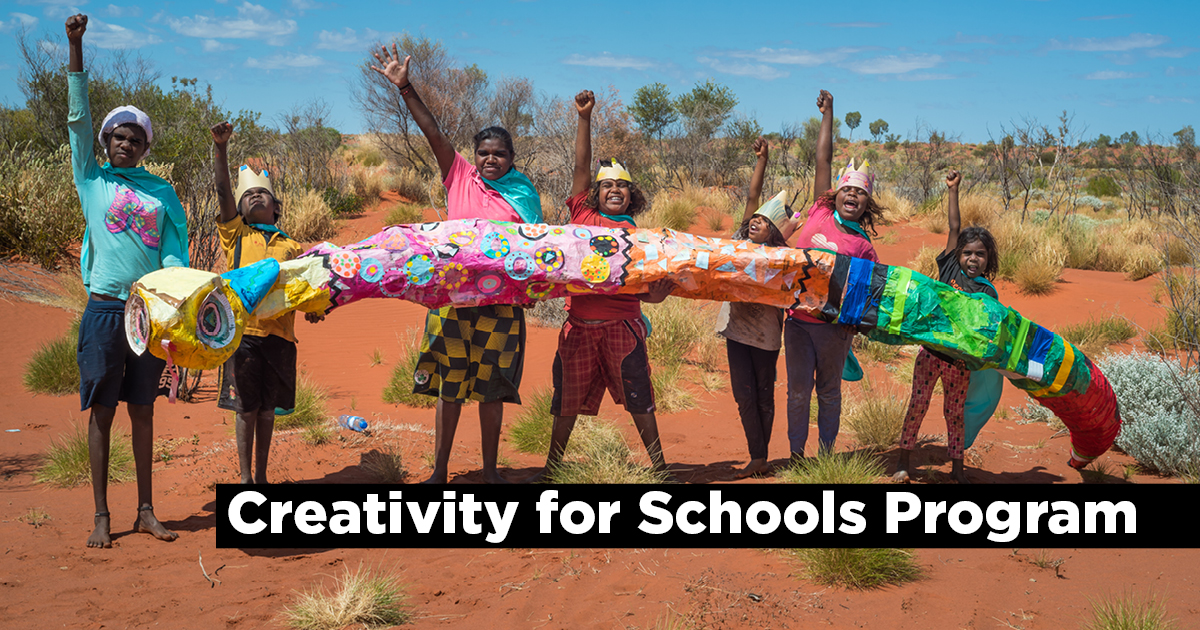 7 Aboriginal students holding a long sculpture in regional WA