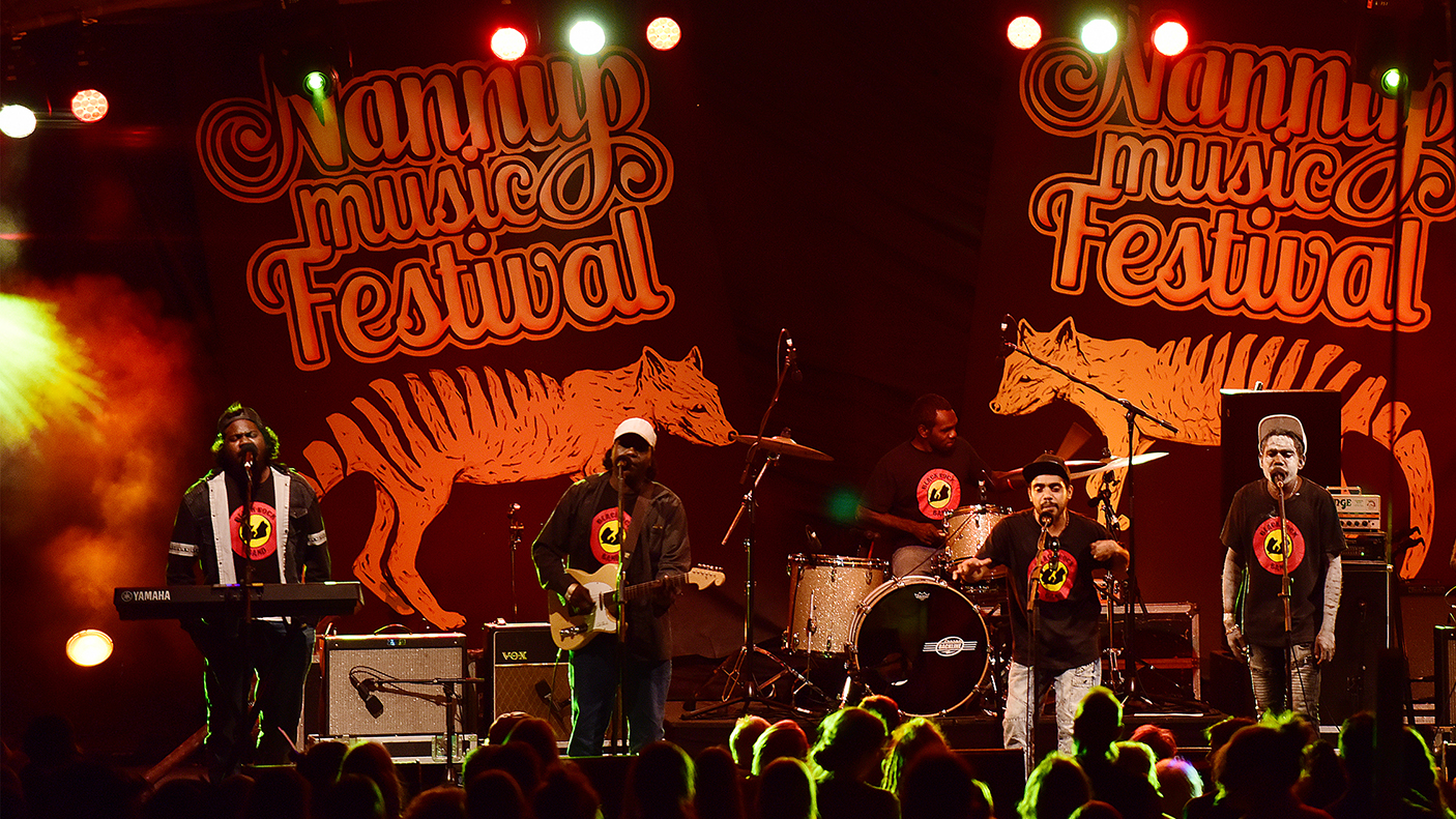 A band of Aboriginal musicians playing on stage