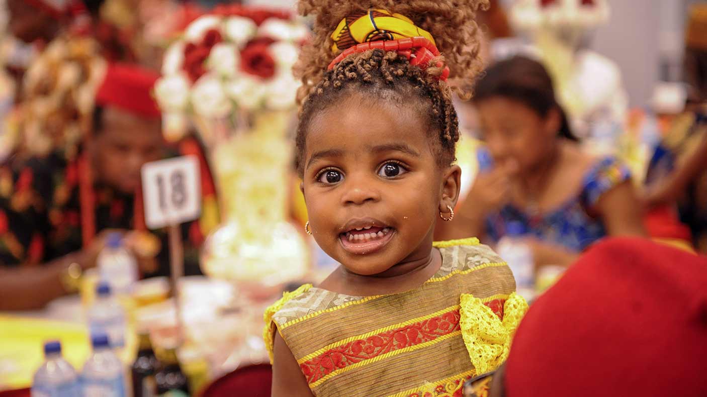 A young girl smiling at an event