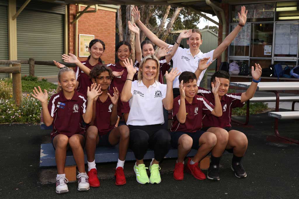Nina Kennedy and Natalie Burton pose with students during the Olympics Unleashed Western Australia