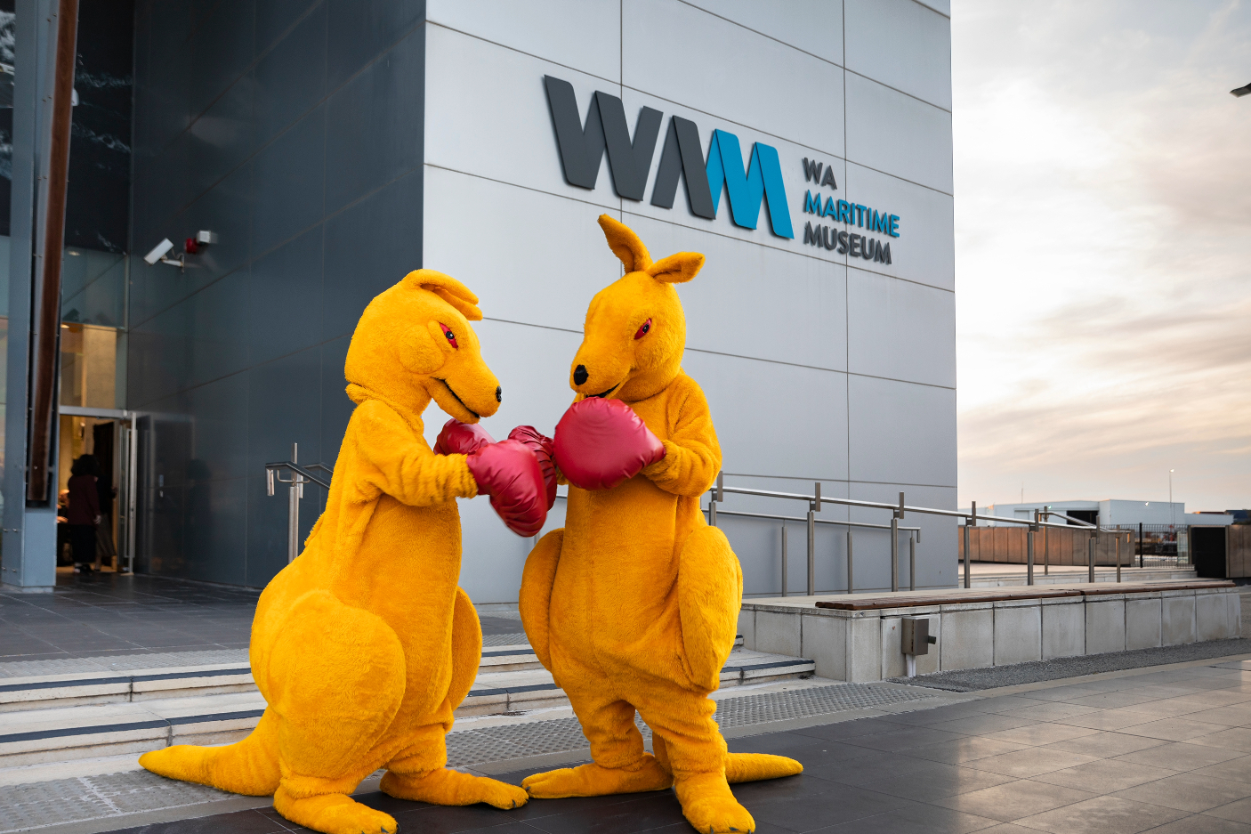 Image outside the WA Maritime Museum with two yellow boxing kangaroos in front.