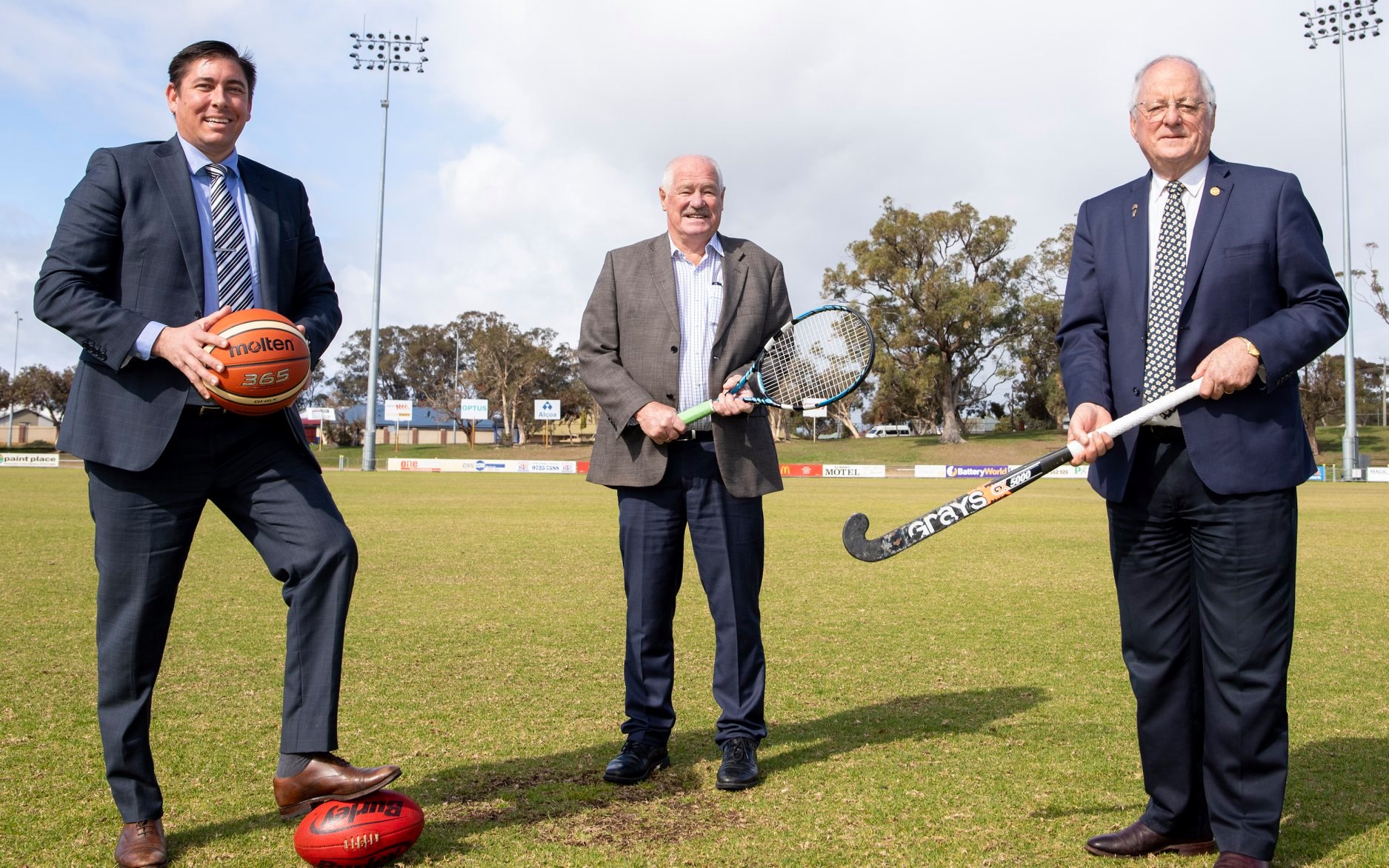 Minister Mick Murray, Shire of Donnybrook Balingup CEO and president holding sports equipment on the Donnybrook and Districts Sporting and Recreation Precinct