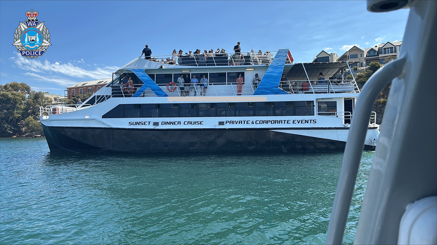 A charter boat on the water with guests on upper and lower decks