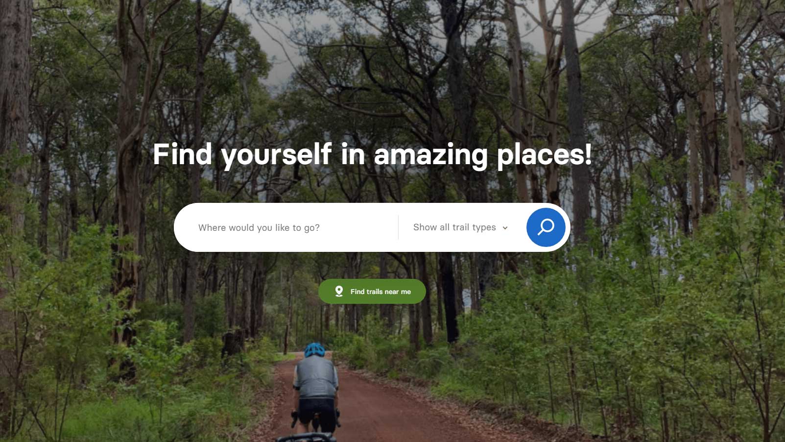 Trails WA website with a search field and the title, find yourself in amazing places. Darkened image of a cyclist on a bush track in the background.