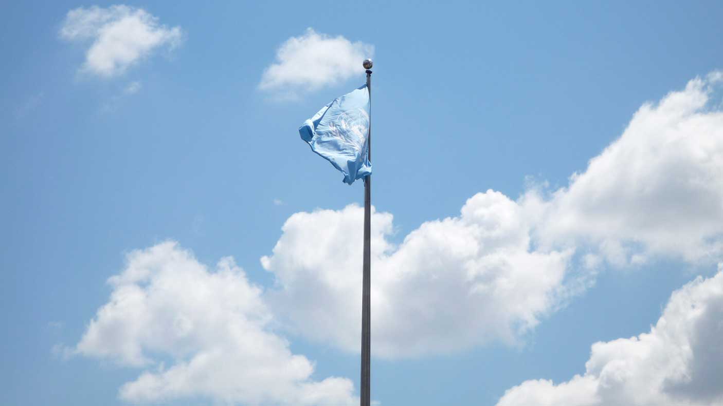 United Nations flag with the sky in the background.