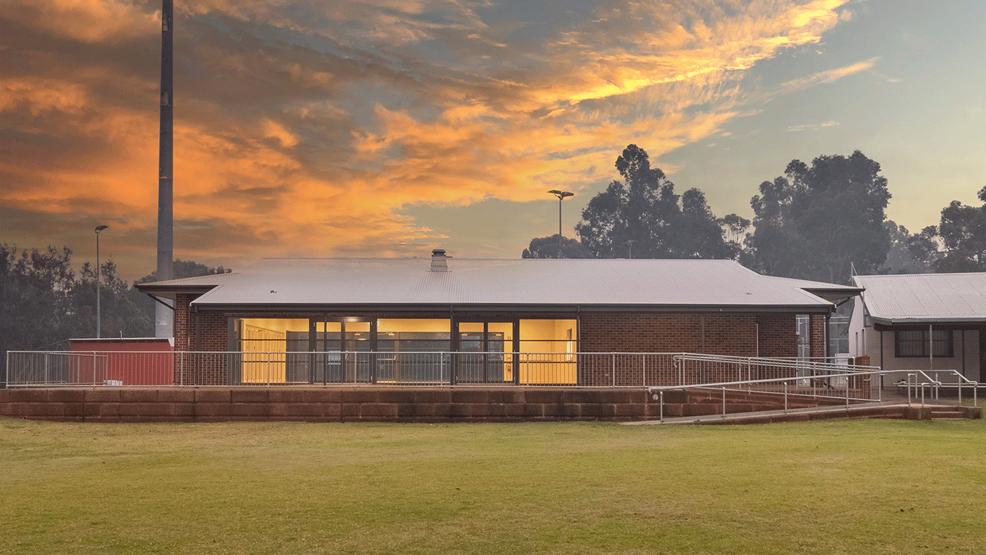 The Elise Austin Pavillion, with grassed area in the foreground, and the sunsetting in the background.