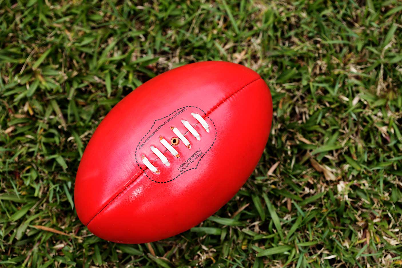 A football laying on grass