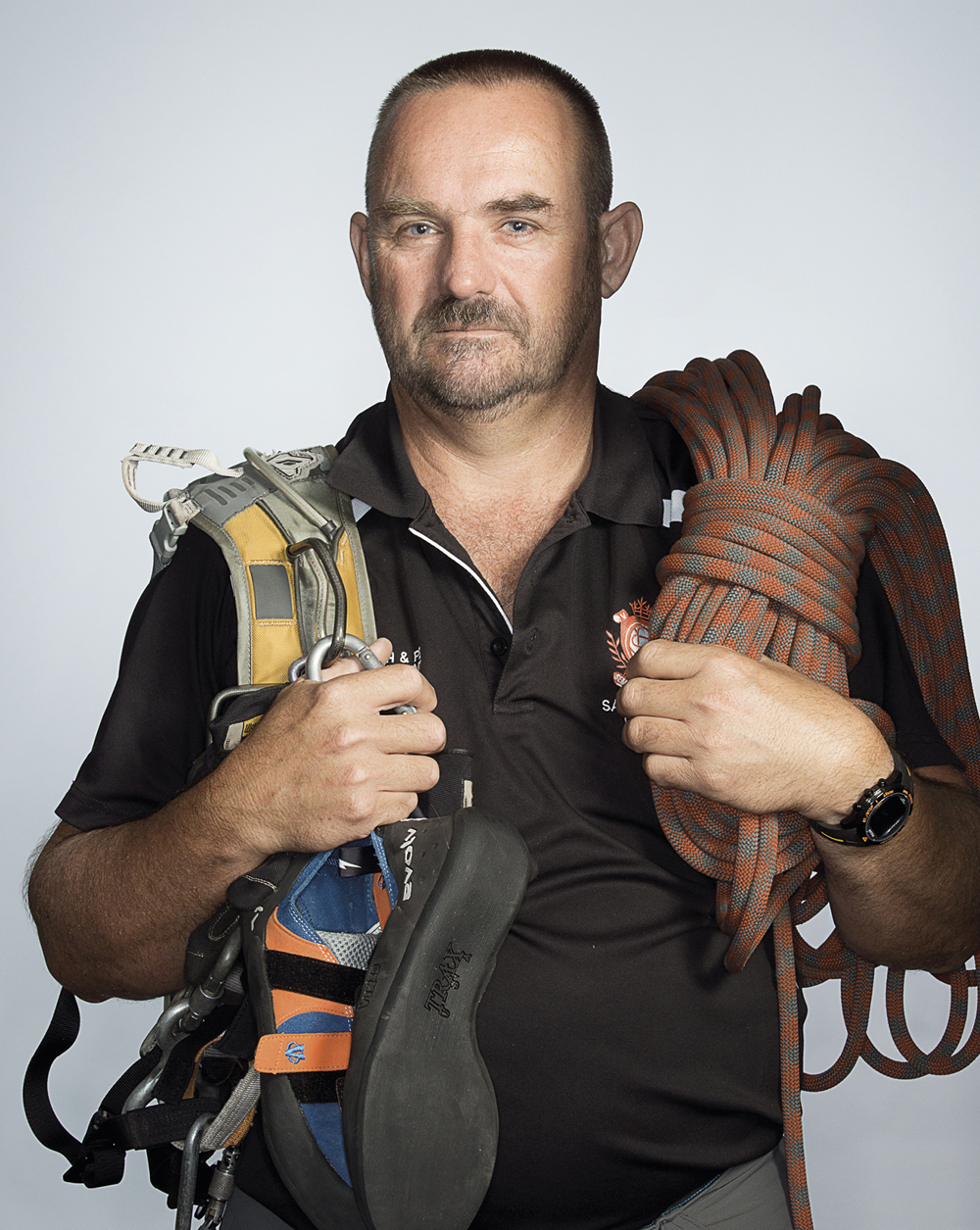 Portrait of Paul Delane holding climbing gear
