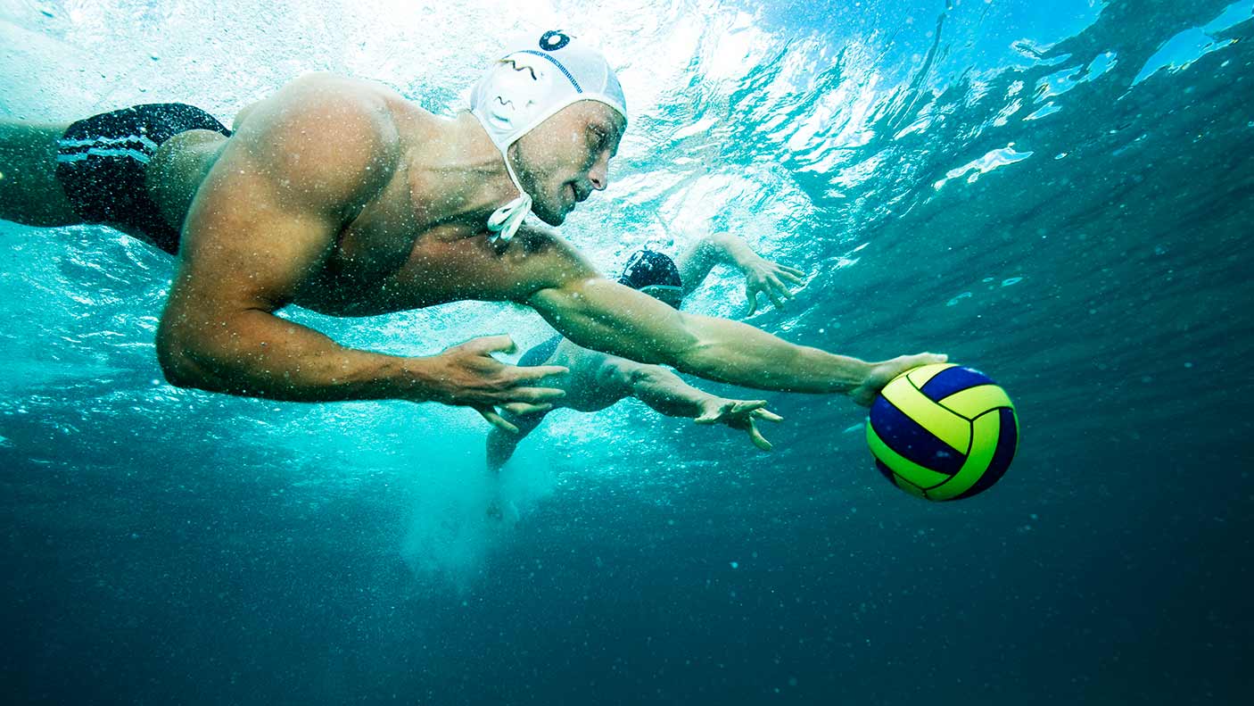Water polo player with ball underwater